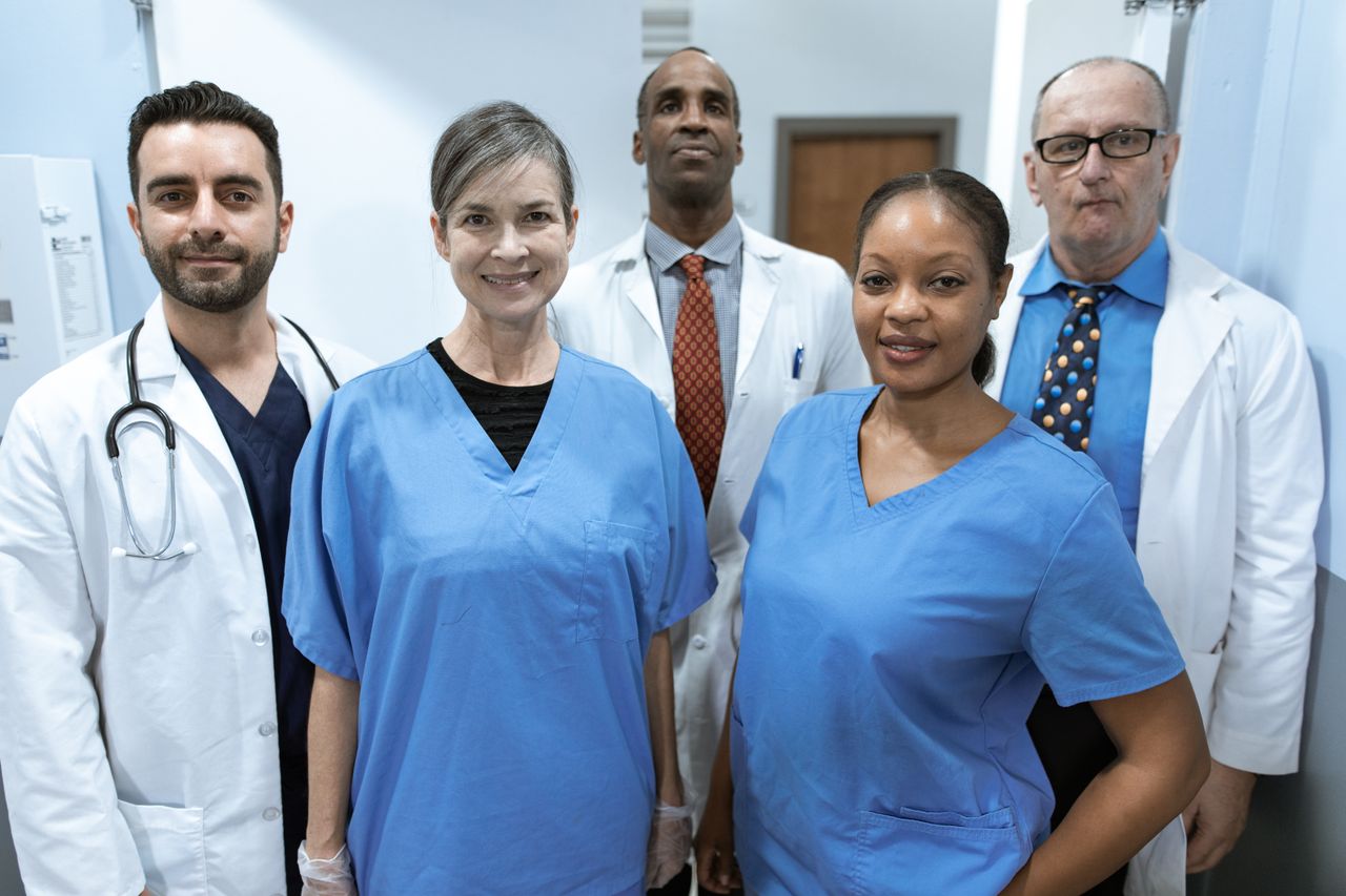 Home Group of diverse healthcare professionals posing confidently indoors.