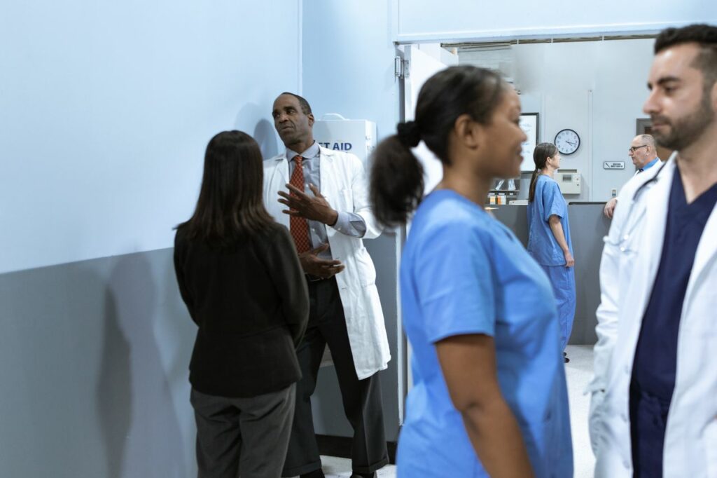Crafting Captivating Headlines: Your awesome post title goes here Doctors and nurses in discussion, showcasing teamwork in a hospital setting.